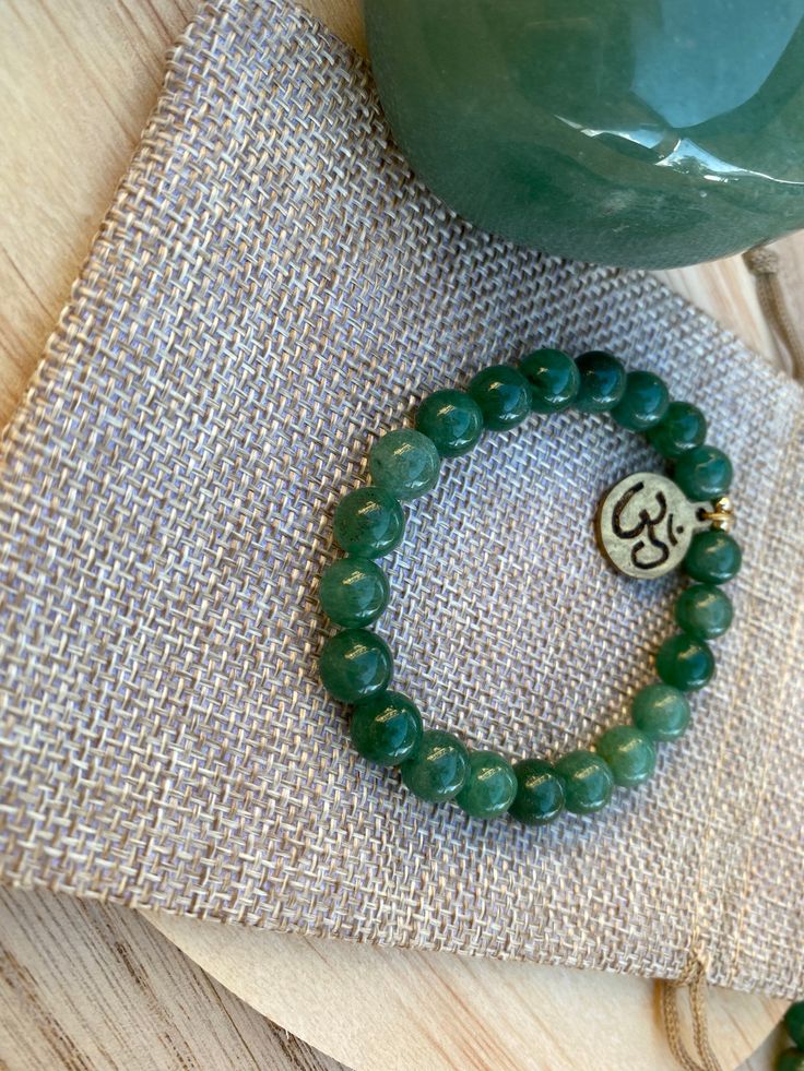 Jade Bracelet*Healing Jewelry*Gemstones Bracelet* Unisex Jewelry *Handmade Jewelry* Om Sign* Yoga Jewelry *Beaded Bracelet* 8 mm Jade Beads Brass Charm Jade -Prosperity -Well Being -Good Luck 🍀 Holistic Jade Beaded Bracelets As Gift, Spiritual Aventurine Bracelets As Gift, Round Aventurine Bracelets For Gifts, Aventurine Bracelet As A Gift, Jade Stretch Bracelet With Natural Stones As Gift, Aventurine Round Bracelet Gift, Round Aventurine Bracelets As Gifts, Jade Crystal Bracelet For Meditation, Spiritual Jade Crystal Bracelet With Gemstone Beads