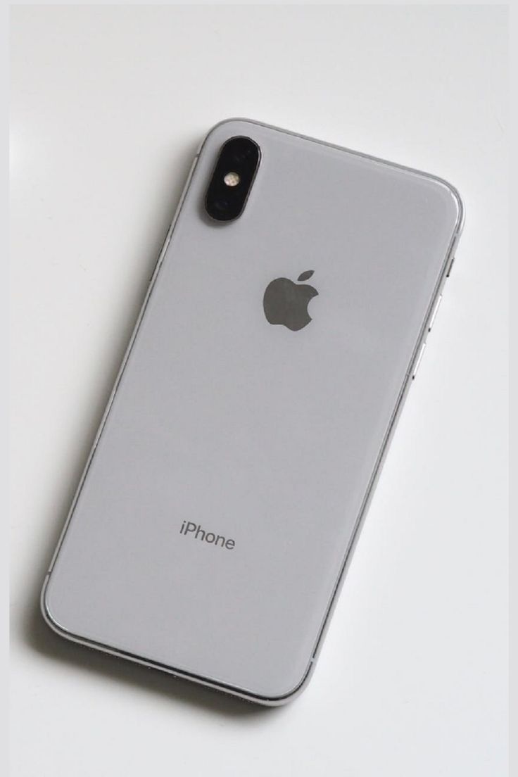 an iphone sitting on top of a white table