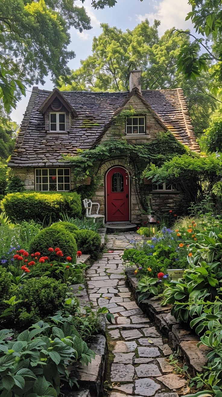 a stone path leads to a red door in the middle of a lush green garden