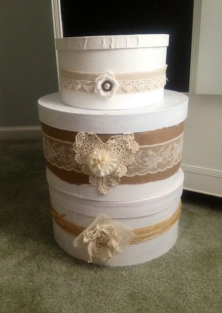 a stack of wedding cakes sitting on top of a green carpeted floor next to a window