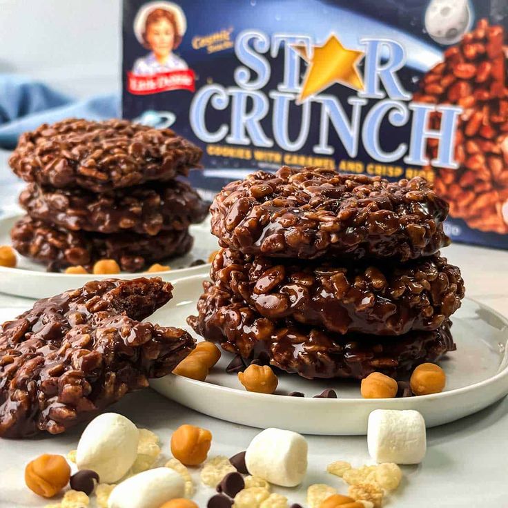 three cookies on a plate with marshmallows and star crunch in the background