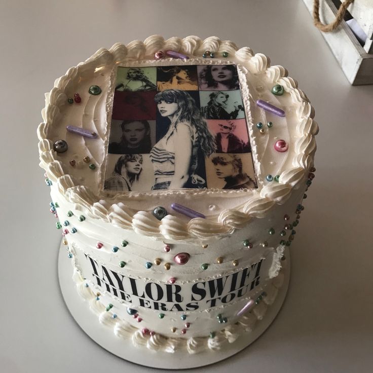 a white cake decorated with photos and confetti