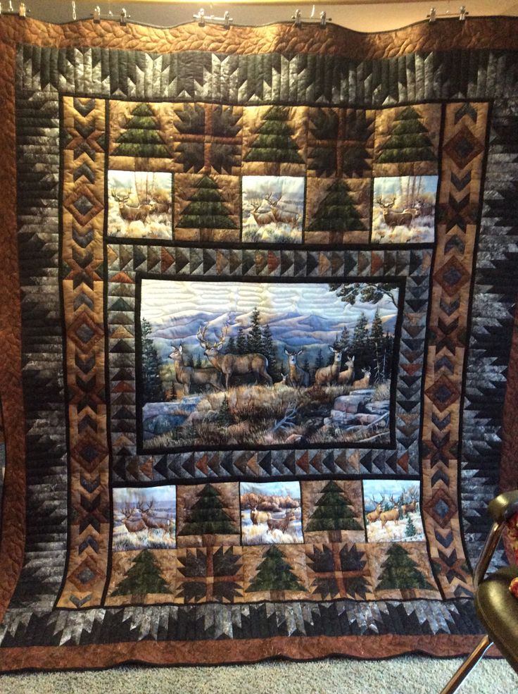 a quilted wall hanging in the corner of a room