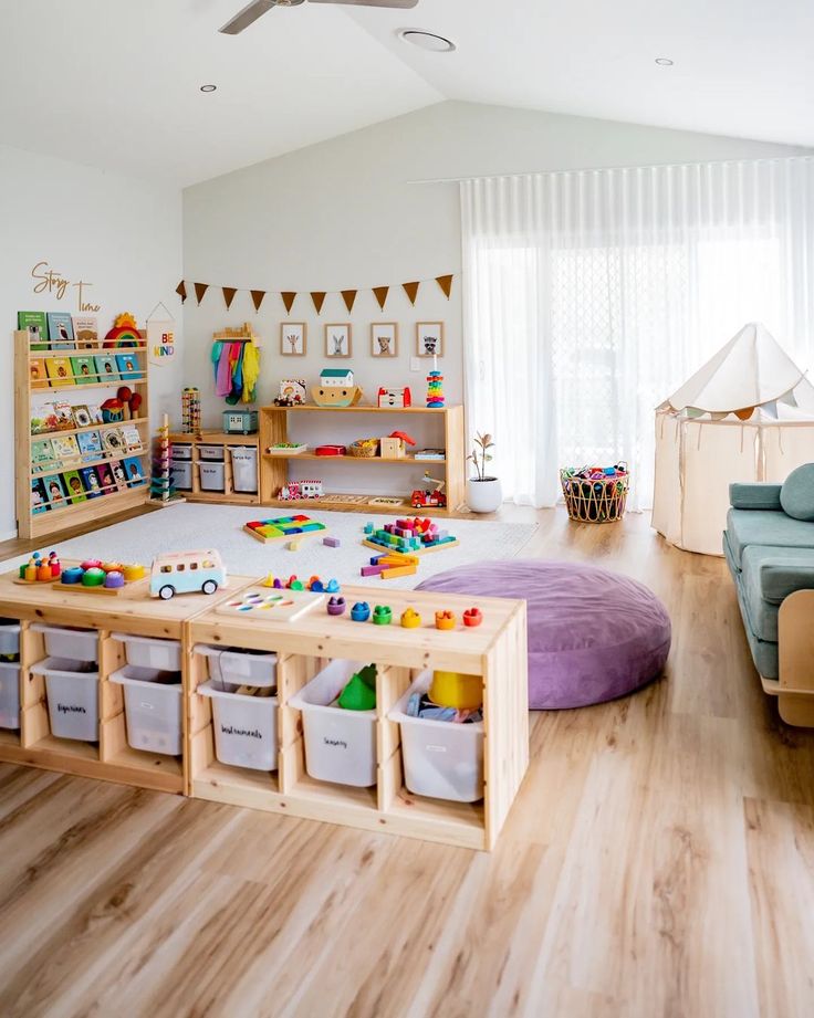 a child's playroom with toys and storage bins