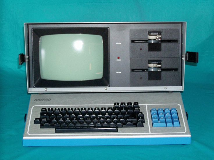 an old computer sitting on top of a blue table