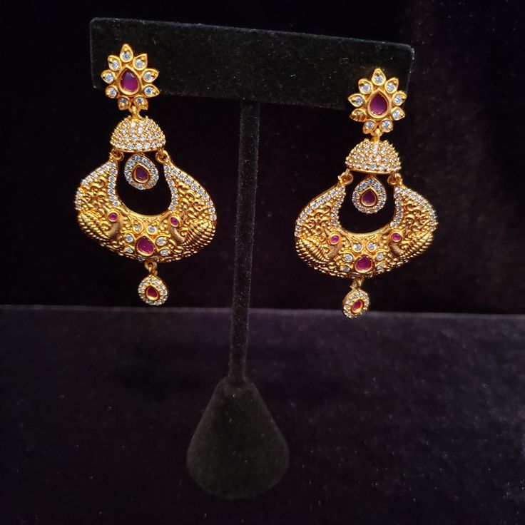 "These Jhumka Earrings set have an excellent finish and gives out an exquisite sense of style. If you are looking for an amazing Fashion Jewelry set for special occasions such as Anniversary, Engagement, Party, Wedding or for gifting , then your search ends here. Handmade Indian Temple Jewelry, best to wear it for traditional ceremonies or Indian wedding. This bridal jewelry has ethnic finish. It has Cubic Zircon stones with ruby and emeralds. It is a Bollywood style one gram jewelry. There are Festive Jewelry Sets With Matching Earrings For Diwali, Formal Bollywood Chandbali Jewelry Sets, Ornate Chandbali Jewelry Sets For Gift, Diwali Jewelry Sets With Matching Earrings For Celebration, Diwali Celebration Jewelry Sets With Matching Earrings, Formal Temple Jewelry Earrings With Latkans, Traditional Jeweled Pearl Earrings For Party, Temple Jewelry Bridal Drop Earrings For Celebration, Celebration Temple Jewelry Bridal Drop Earrings