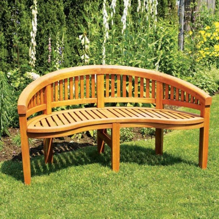 a wooden bench sitting on top of a lush green field