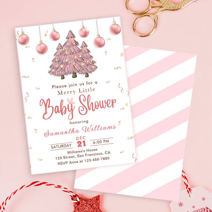 a pink and white christmas baby shower with ornaments on it, scissors and other items