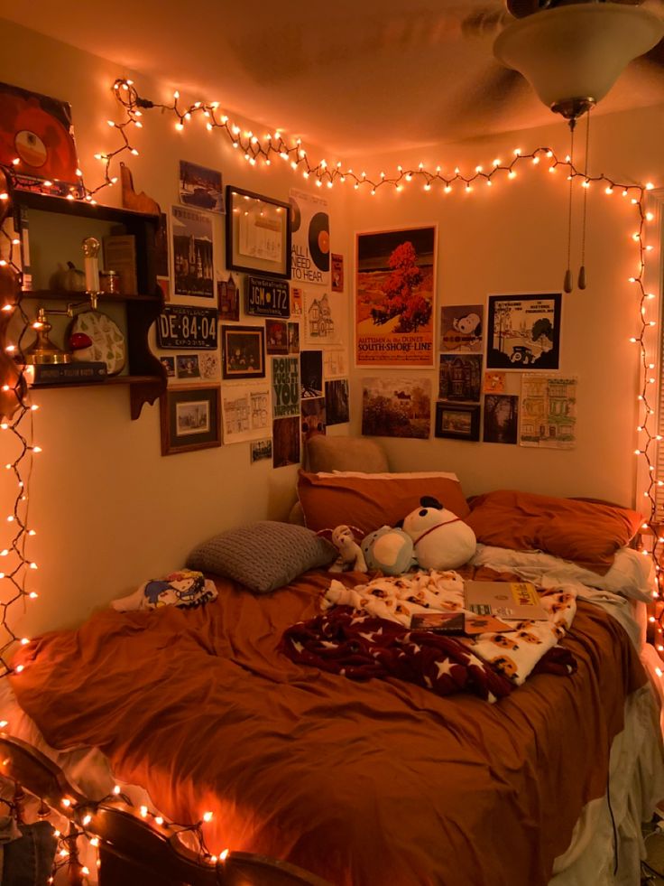 an unmade bed with lots of lights on the wall