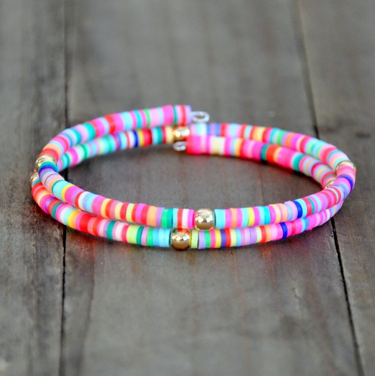 This fun bracelet is made of a colorful mix of clay disc beads randomly strung on memory wire with gold toned accent beads. Boho Charm Bracelet, Red Beaded Bracelet, Beaded Leather Wraps, Boho Wrap Bracelet, Coil Bracelet, Fun Bracelet, Memory Wire Bracelet, Bead Loom Bracelets, Beads Bracelet Design