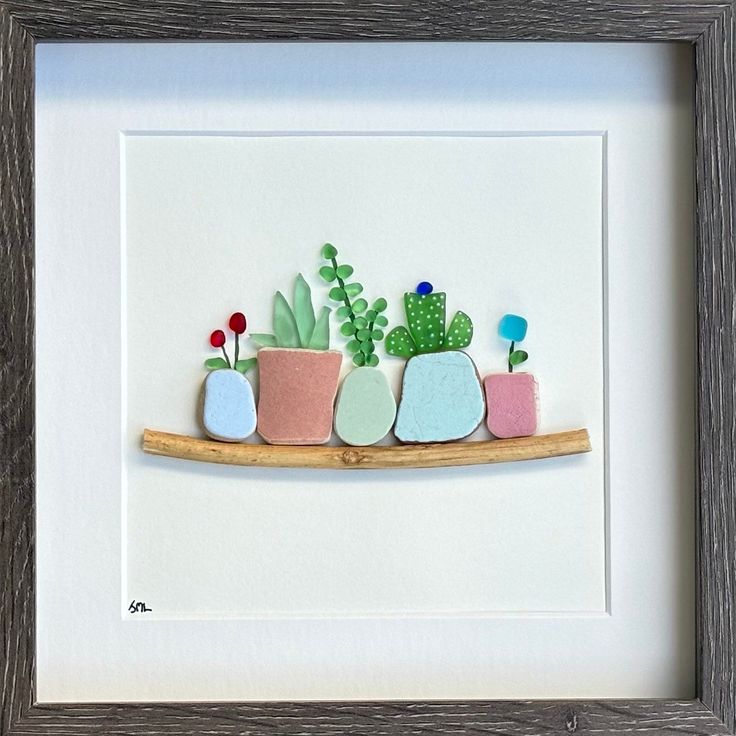 three potted plants sitting on top of a wooden shelf in front of a white wall