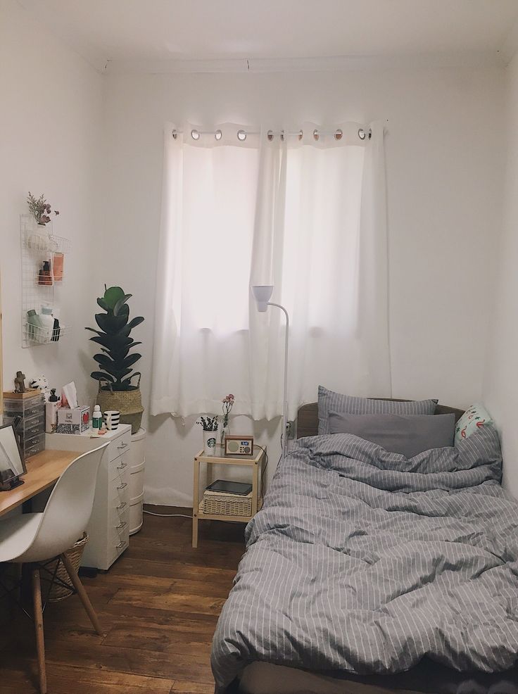 a bedroom with a bed and desk in it