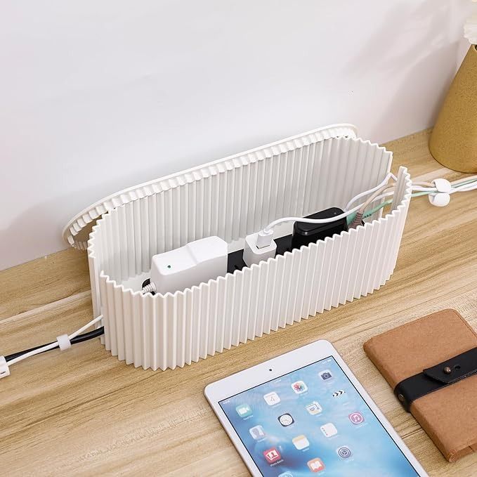 an electronic device is plugged into the side of a heater on a table