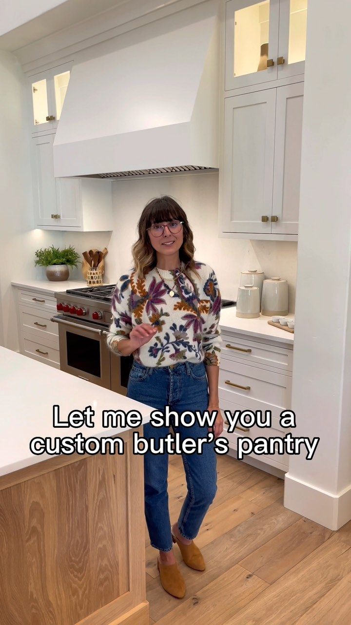 a woman standing in a kitchen next to a counter top with the words let me show you a custom butters pantry