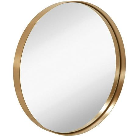 a round mirror with a gold frame