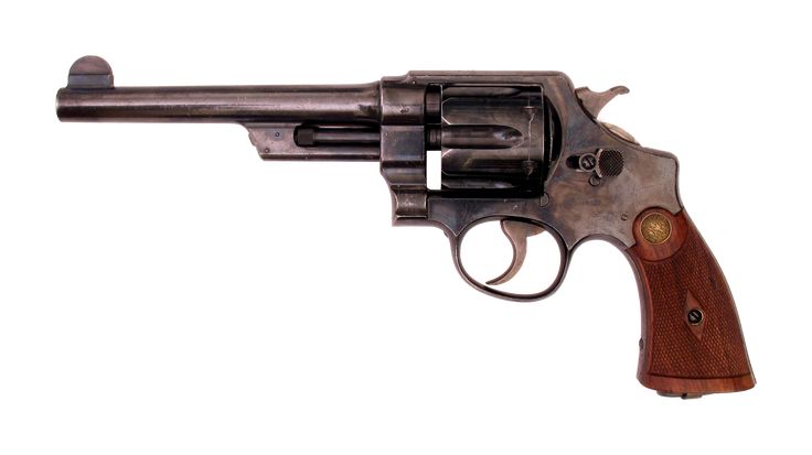 an old revolver with wooden grips on a white background and clippings to the side