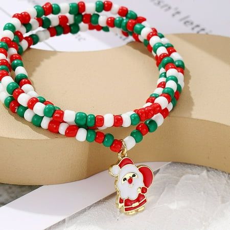 the bracelets are decorated with red, white and green beaded beads that have a santa clause charm on them