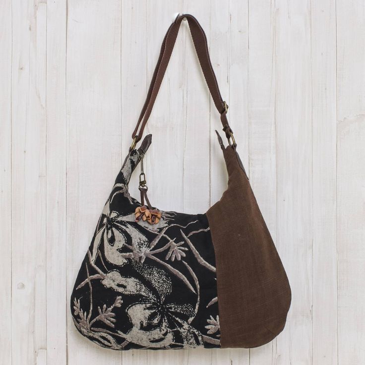 From Thai designer Sansanee Krasae this eye-catching cotton handbag features a floral print inset. In tones of silver deep black and rich brown it opens to reveal a zipper pocket and two open compartments. The zipper pull is adorned with a leather flower. Cheap Bohemian Brown Shoulder Bag, Cheap Bohemian Brown Bags, Hobo Purses And Handbags, Cheap Vintage Bags For Fall, Affordable Vintage Bags For Fall, Hobo International Handbags Vintage, Affordable Vintage Women's Bags, Fair Trade Gifts, Black Reversible Canvas Bag