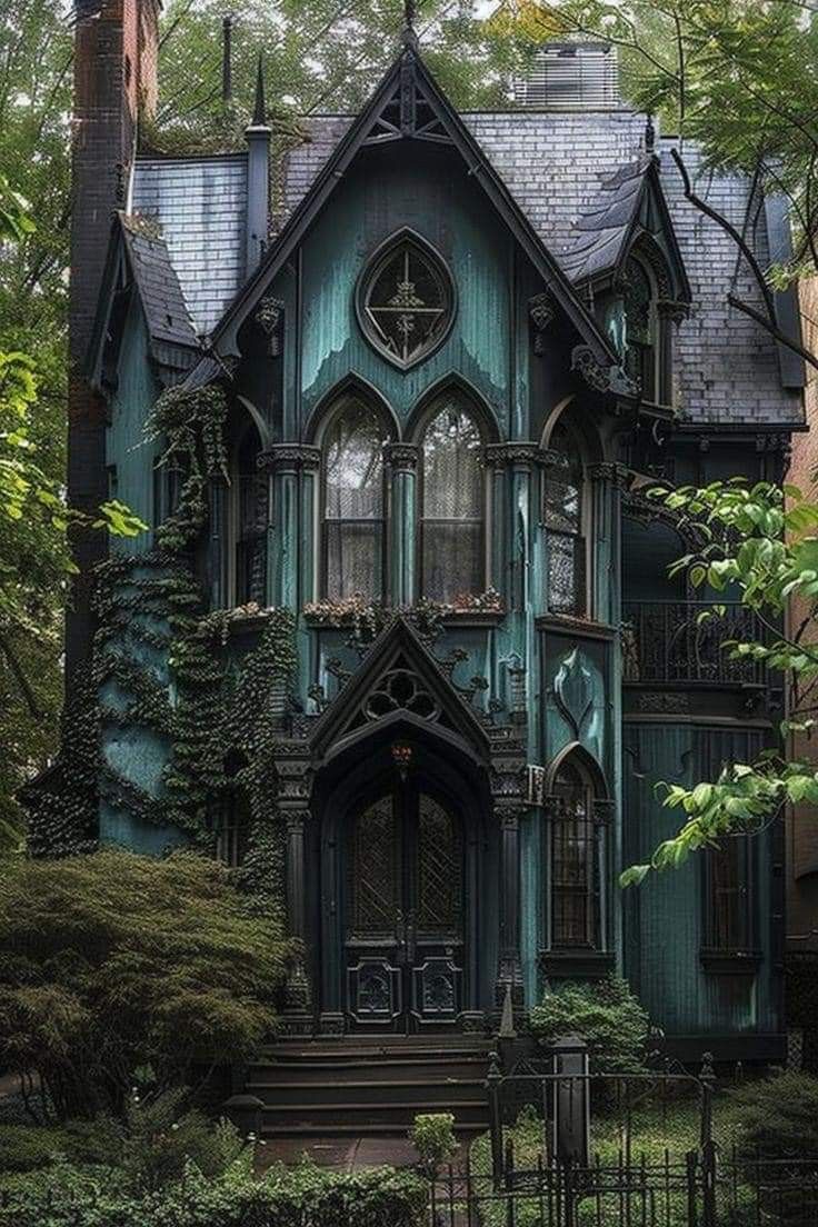 an old style house with ivy growing on the windows and door, surrounded by greenery