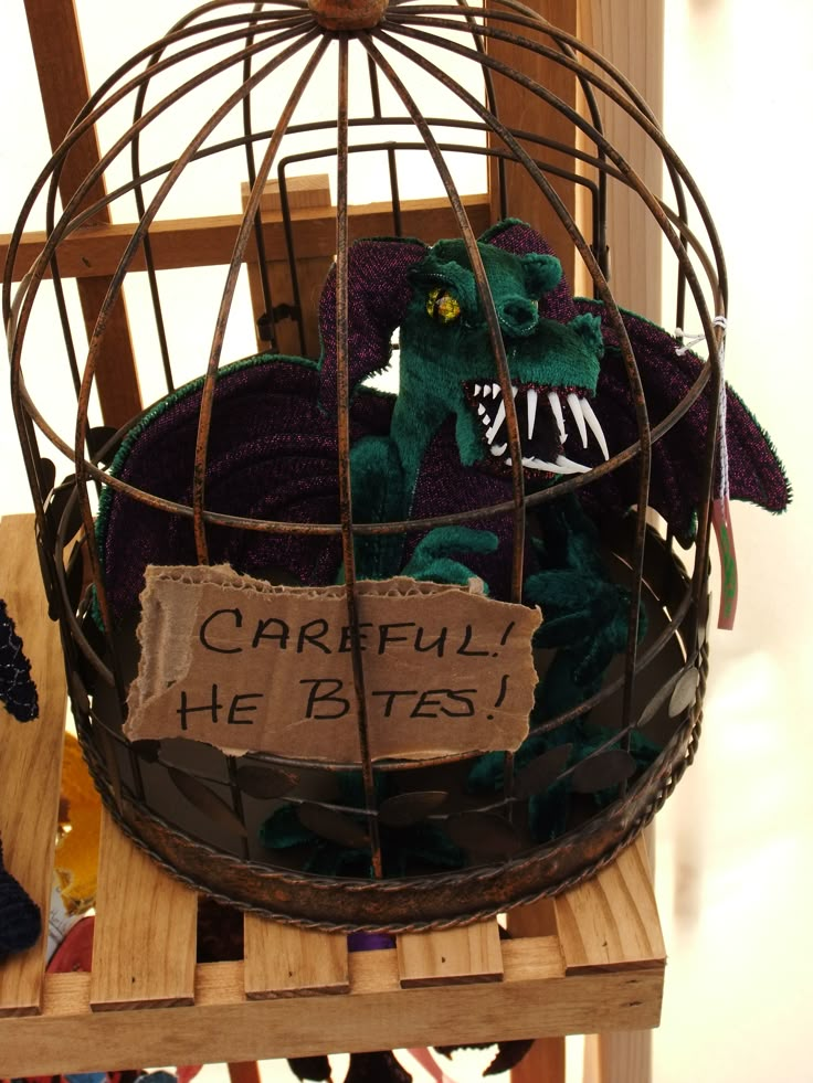 a stuffed animal in a cage that says careful he bites