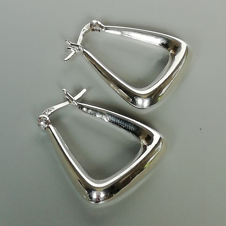 IMPORTANT **Please go through all the pictures i have posted for a listing with a ruler, on a model, on my hand, to get an exact idea of the actual size of the item. ONE PAIR of triangle sterling silver hoops. Dimensions: 22 x 25 x 5 mm. Weight: 5.6 gm These earrings are made of 925 hypoallergenic sterling silver. This piece is marked with 925 stamp for authenticity. Can be packaged in a gift box. I can include a personal message from you if needed You are welcome to contact me at... bhavnakwint Hoops Silver, Jewelry Lookbook, Skull Earrings, Sterling Silver Hoops, Jewelry Inspo, Toe Rings, Jewelry Earrings Hoops, Ear Jewelry, Silver Hoops