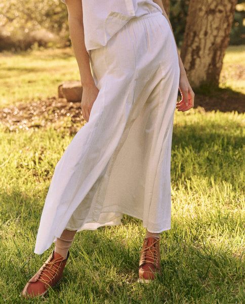 The Godet Skirt. takes cues from a 1930s gown, reimagined through our signature casual lens. The easy, pull-on skirt has an elasticated waistline with a top block that loosely flatters the hips while the godet insets add volume to the sweeping hemline. Style it back to The County Top. for a sweet and charming set. Summer Rayon Maxi Skirt With Elastic Waistband, Spring Maxi Skirt With Gathered Waist, Summer Rayon Tiered Skirt, Summer Tiered Skirt In Rayon, Summer Tiered Rayon Skirt, Flowy Maxi Skirt With Gathered Waist For Summer, Spring Relaxed Maxi Skirt With Gathered Waist, Summer Maxi Skirt With Gathered Waist, White Bottoms With Gathered Waist For Spring