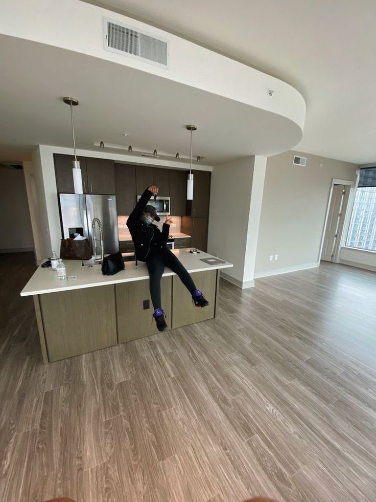 a person jumping in the air over a kitchen counter