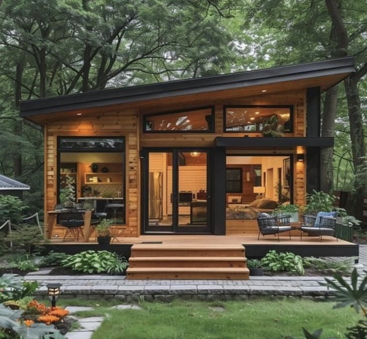 a small wooden cabin sitting in the middle of a forest