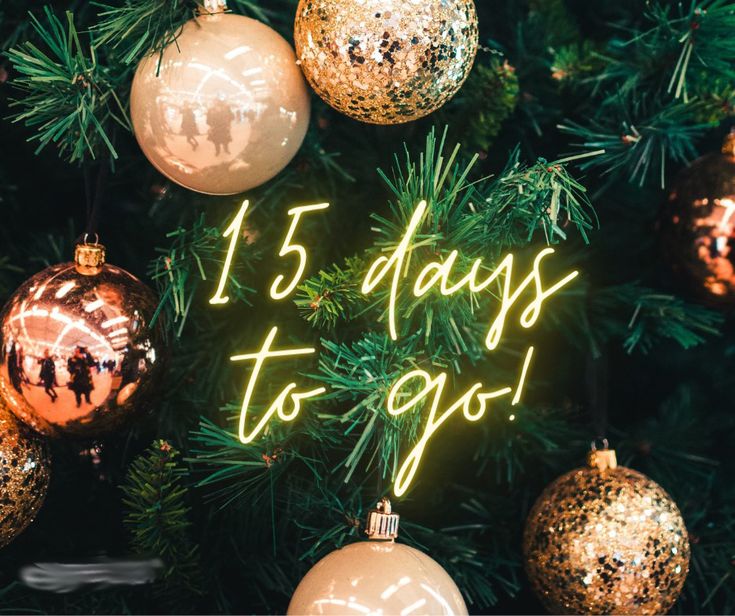 a christmas tree with ornaments and the words 15 days to go written in gold on it