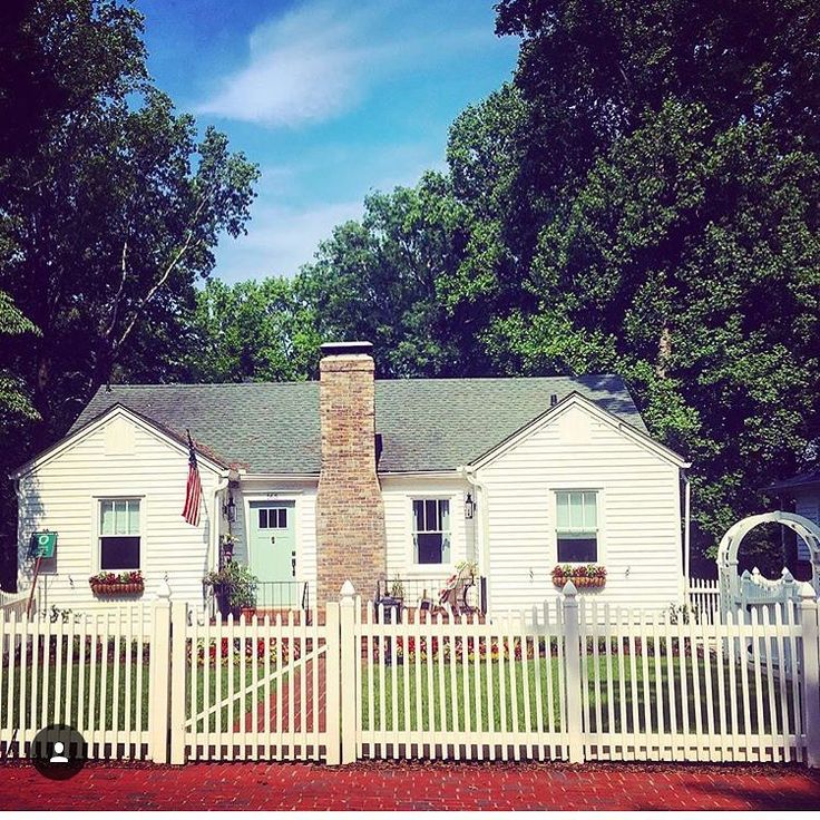 a white house with a picket fence around it