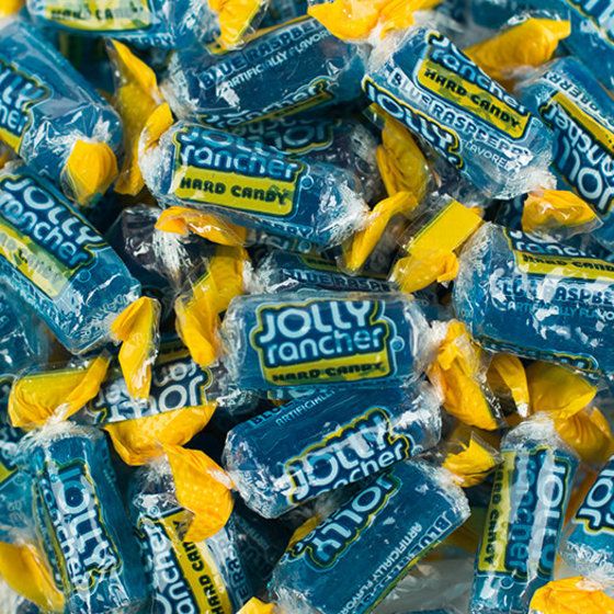 a pile of blue and yellow candies sitting on top of each other in wrappers