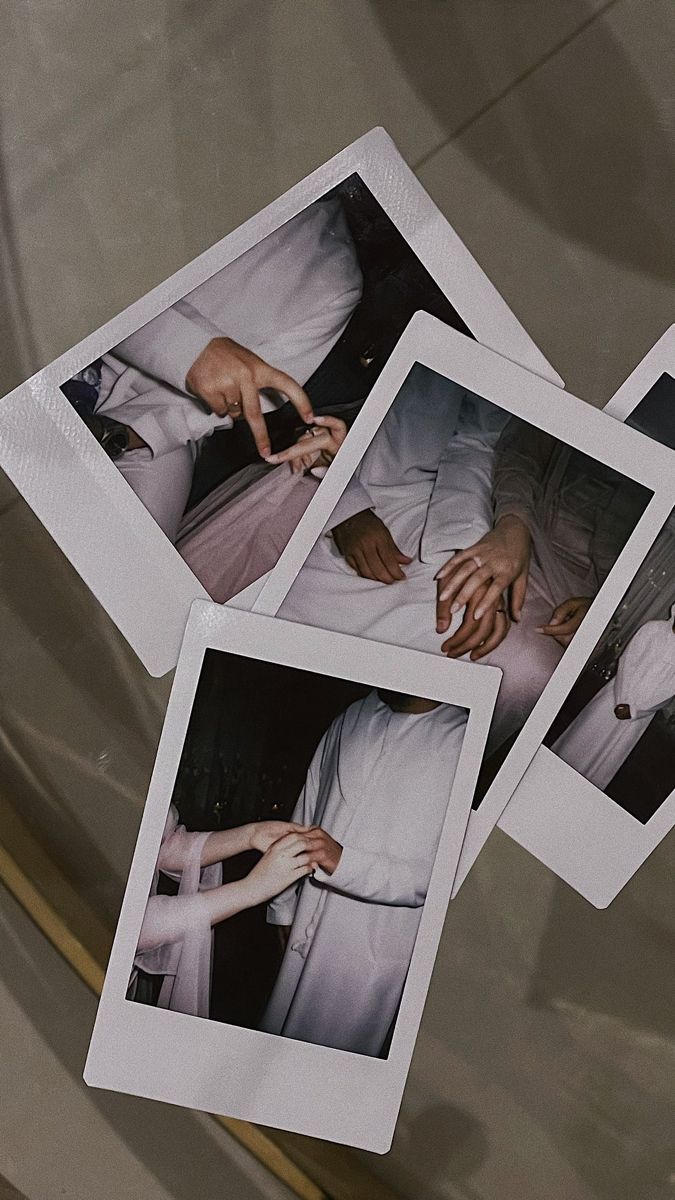 four polaroid pictures of hands touching each other's fingers on a glass surface