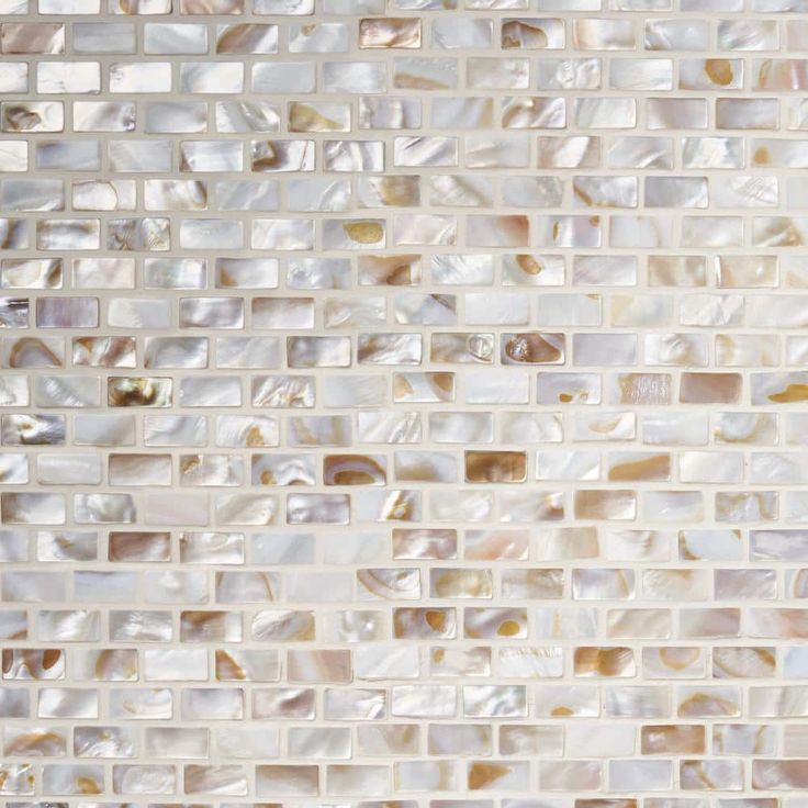 a close up view of a tile wall with white and brown tiles on the side