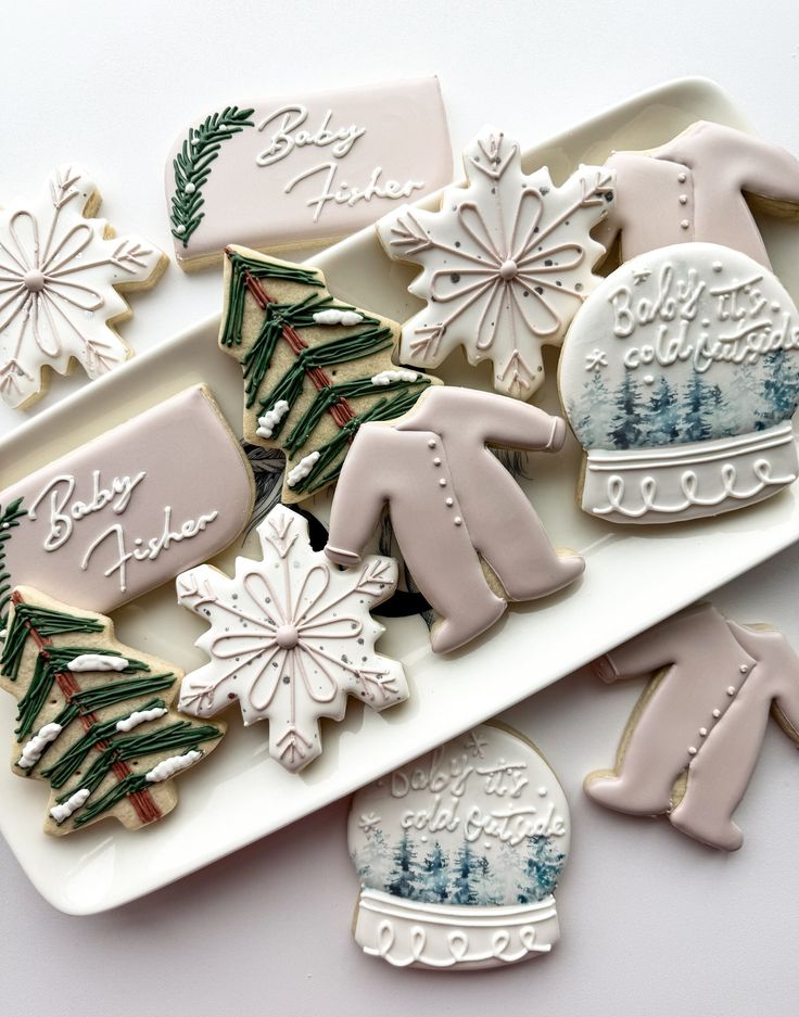 decorated christmas cookies on a platter with snowflakes, mittens and gloves