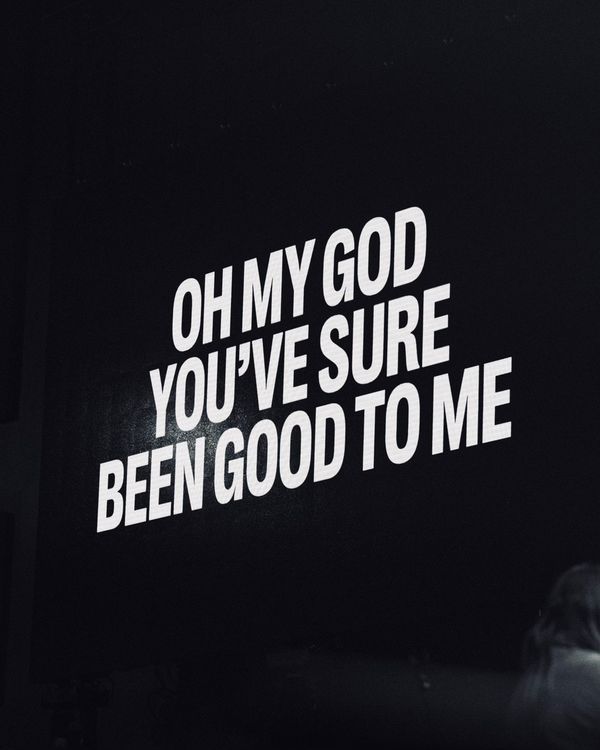 a person standing in front of a sign that says oh my god you've sure been good to me