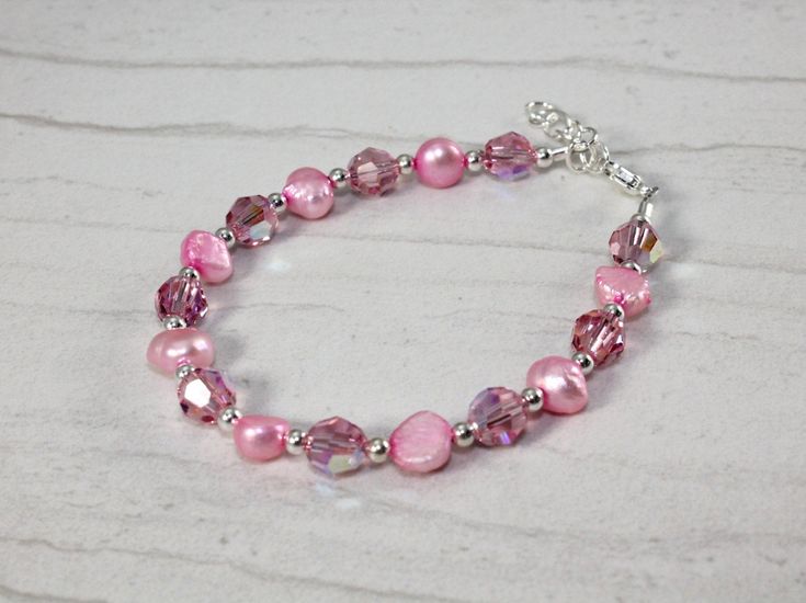 Such a great gift for any little girl who loves pink. This lovely bracelet is made with swarovski crystals,fresh water pearls and delicate sterling silver beads. Shipped in a chiffon gift bag ready for gifting. The perfect gift for a special little girl. Elegant Pink Hypoallergenic Beaded Bracelets, Elegant Pink Hypoallergenic Bracelet, Pink Pearl Bracelet Gift, Personalized Pink Pearl Bracelet For Birthday, Adjustable Pink Pearl Bracelet Gift, Pink Hypoallergenic Bracelets For Wedding, Pink Adjustable Pearl Bracelet For Mother's Day, Personalized Pink Pearl Bracelet With Round Beads, Pink Beaded Jewelry Birthday Gift