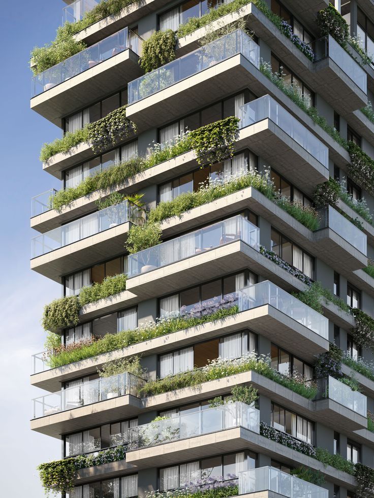 a tall building with lots of balconies and plants growing on the side of it