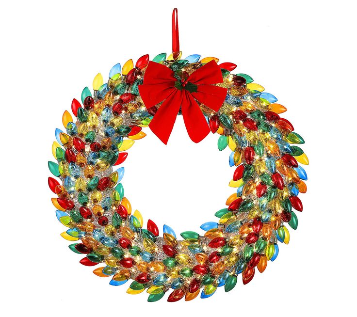 a christmas wreath with red bow hanging from it's front loop, decorated with multicolored glass beads