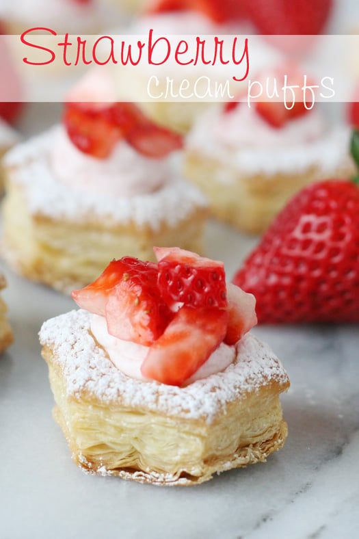 strawberry cream puffs with powdered sugar and fresh strawberries on the top are ready to be eaten