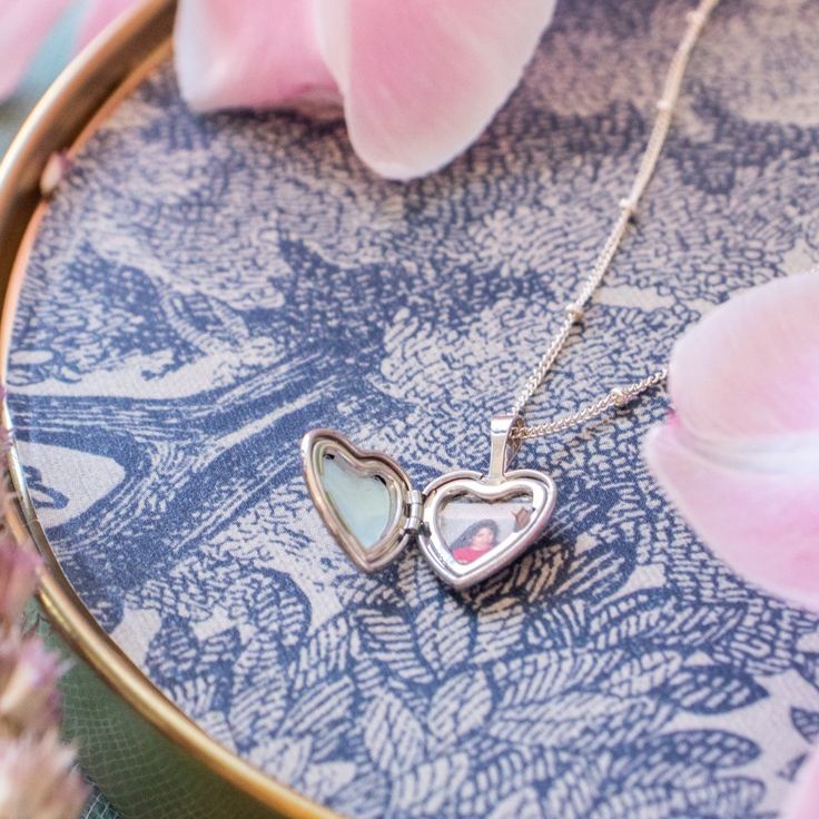 The heart locket necklace is a lovely and meaningful accessory made from 14K gold filled material, perfect for everyday wear. It features a charming heart-shaped pendant that opens up to reveal a small compartment inside, where you can add a photo or personal note, making it a personal and sentimental keepsake. The necklace is a casual yet heartfelt way to keep someone special close to your heart.…………………………………. Details: Pendant is Sterling Silver, heart-shaped locket, measuring 18 x 12.3mm Chain Dainty Open Heart Locket Necklace With Heart Charm, Dainty Open Heart Locket Necklace, Dainty Double Heart Locket Necklace, Double Heart Locket Charm Necklace For Keepsake, Keepsake Double Heart Locket Charm Necklace, Dainty Open Heart Locket Necklace For Keepsake, Double Heart Locket Necklace Keepsake, Double Heart Locket Necklace For Keepsake, Heart Pendant Locket Charm Necklace For Keepsake