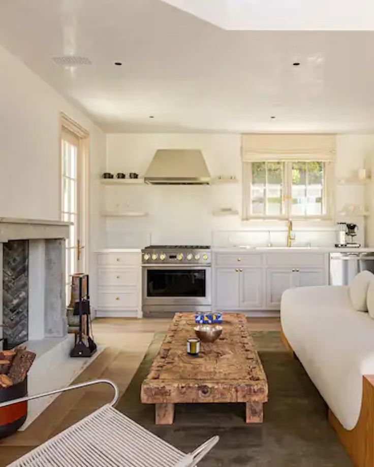 a living room filled with furniture and a fire place