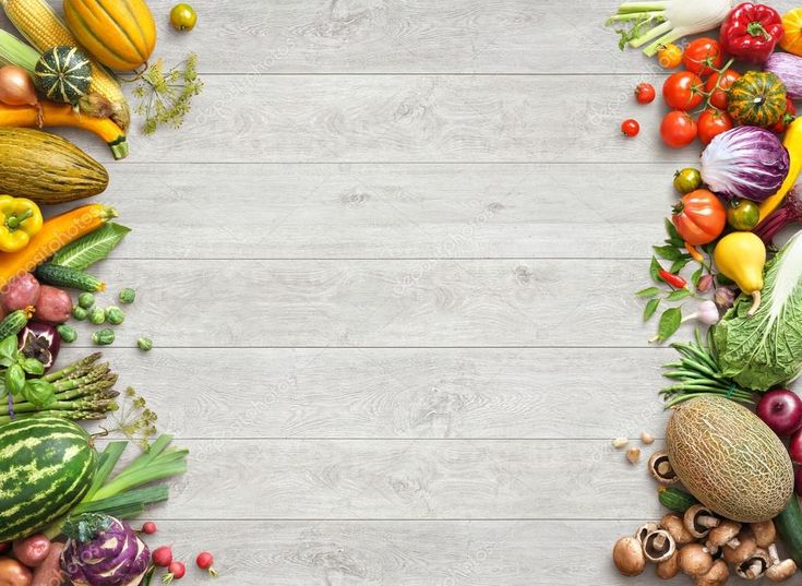 various fruits and vegetables arranged in the shape of a rectangle on a white wooden background stock photo