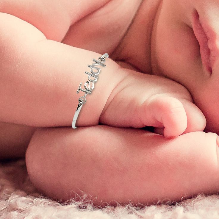 Your baby will look adorable with our personalized name bangle. The nameplate measures approximately 1" x 0.28" depending on the number of letters, the bangle size 4 measures 4 inches, size 5 measures 5 inches, and size 5.5 measures 5.5 inches around. This Baby Bracelet is available in either: Silver Plated, Gold Plated, Sterling Silver, or 14k Gold Over Sterling Silver. Silver Baby Bracelet, Monogrammed Cufflinks, Leather Kits, Baby Bangles, Monogram Bracelet, Swarovski Heart, Crown Necklace, Name Earrings, Baby Bracelet