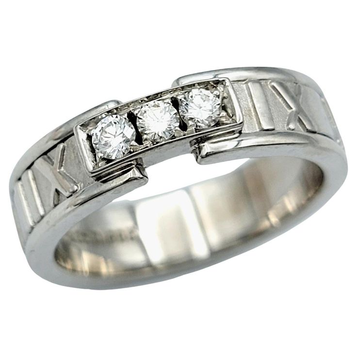 a white gold ring with three diamonds