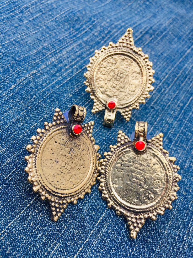 * This complete vintage coin set includes a necklace, a pair of earrings, and a ring, is an epitome of tradition, as the design of the set is inspired by the Afghani Kuchi ornaments. The rusty gold toned set is embellished with dangling elements, adorned with intricate patterns and archaic motifs. The pair of earrings, coin shaped, complete the set in an astonishing manner, complimented by the antique ring in the identical design. You can pair this complete traditional set with any traditional o Antique Metal Jewelry For Festivals, Bohemian Brass Coin Necklace, Bronze Brass Coin Pendant Necklace, Bronze Brass Jewelry With Coin Pendant, Antique Gold Jewelry With Coin Pendant, Antique Gold Coin Pendant Jewelry, Bronze Brass Pendant Coin Necklace, Antique Metal Jewelry With Round Pendant, Nickel Free Brass Coin Pendant Necklace