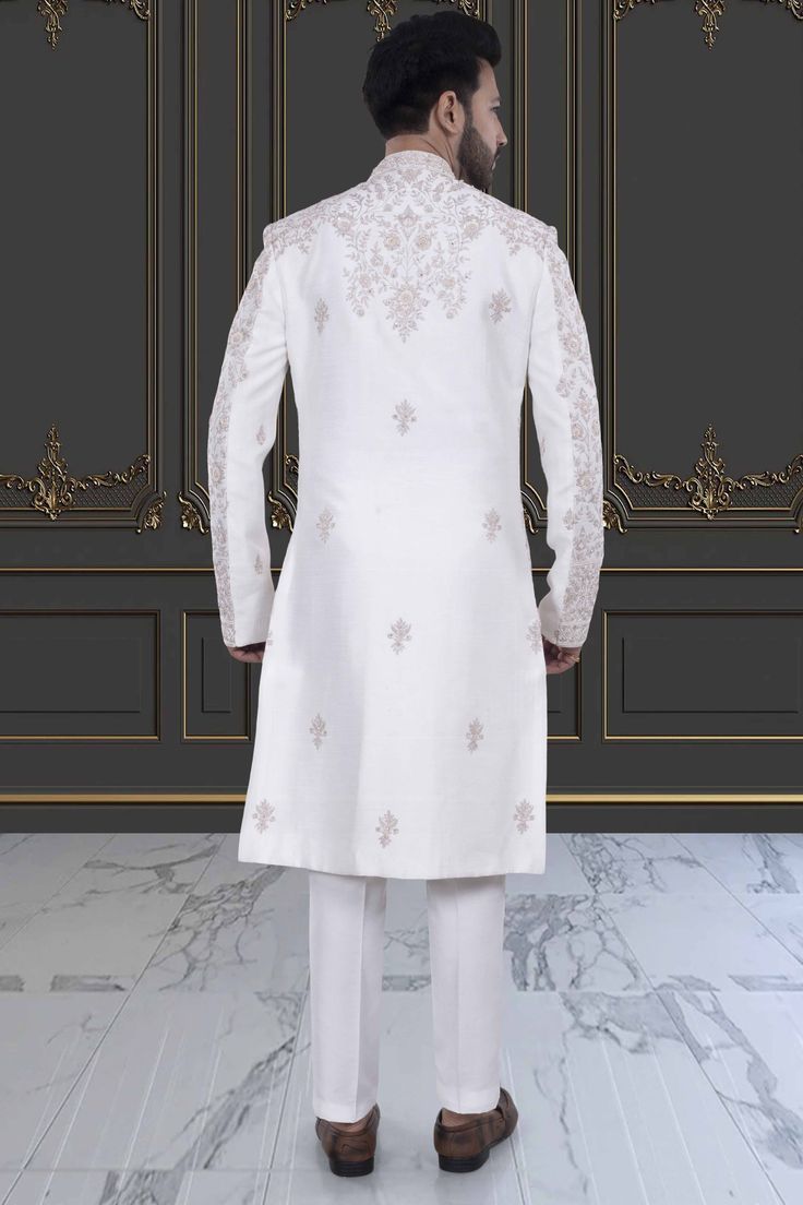 This impeccable sherwani, adorned with luxurious stones and intricate embroidery, exudes sophistication and elegance. Perfect for the stylish groom, it is a timeless masterpiece that will make a lasting impression. Indulge in the opulence and elevate your wedding day look with this R14-S71 sherwani. Traditional White Kurta With Naqshi Drape, White Kurta With Naqshi And Traditional Drape, White Kurta With Naqshi In Traditional Drape, White Traditional Wear With Naqshi, White Traditional Wear With Naqshi Drape, Elegant Traditional Wear With Naqshi, Elegant Traditional Wear With Naqshi Drape, Elegant Traditional Wear With Naqshi In Traditional Drape, Transitional White Naqshi Churidar