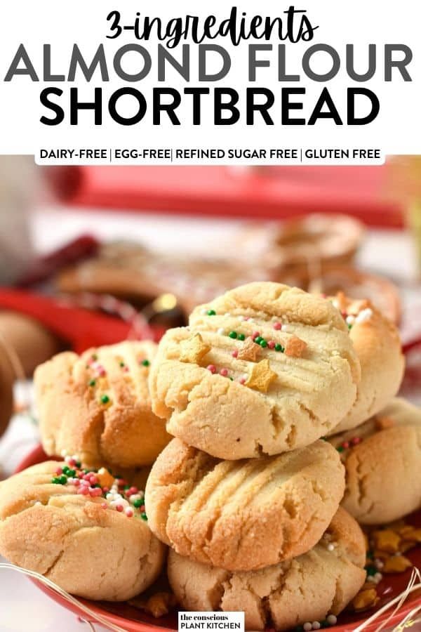 three ingredient almond flour shortbread cookies stacked on top of each other in a red bowl