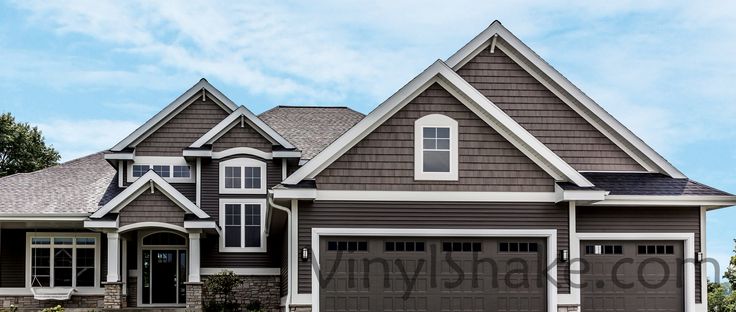 a large house with two garages on the front and one above it's door