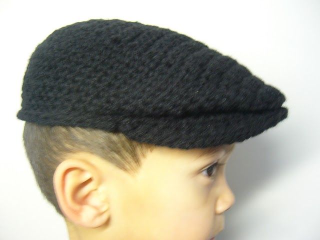 a young boy wearing a black knitted hat