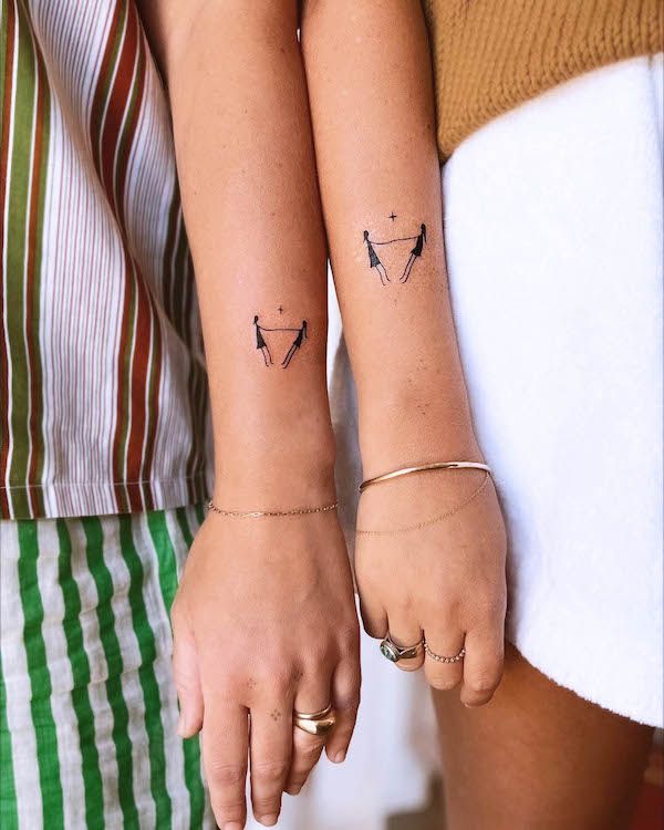 two people with matching tattoos on their arms